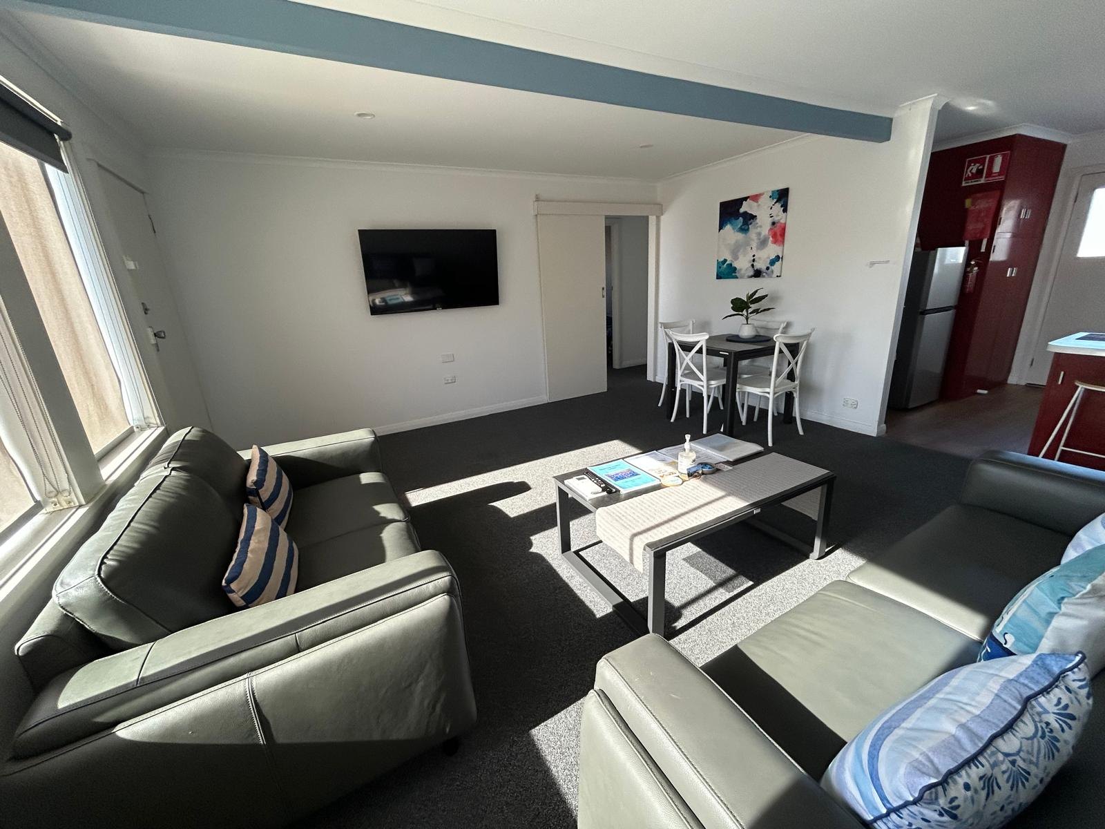 Lounge seating with flat-screen TV in Apartment One