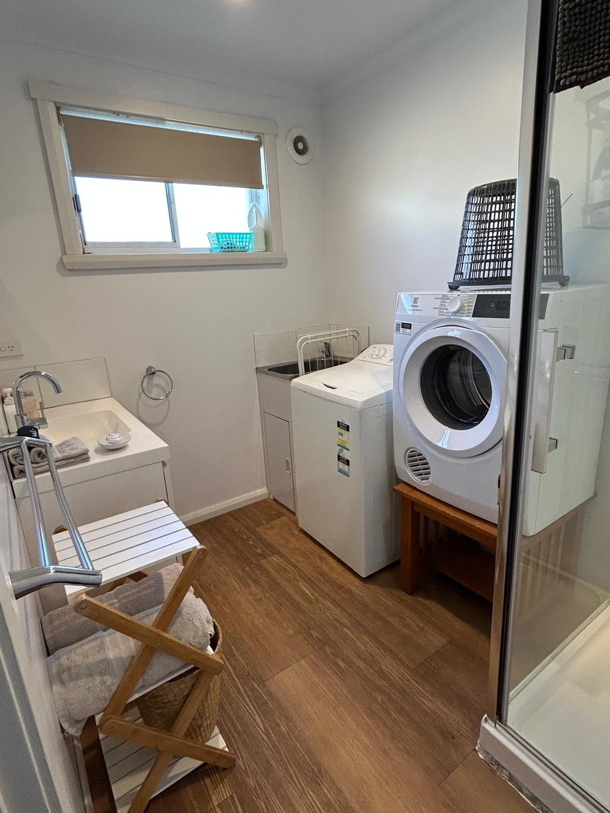 Laundry with washing machine and dryer in Apartment One