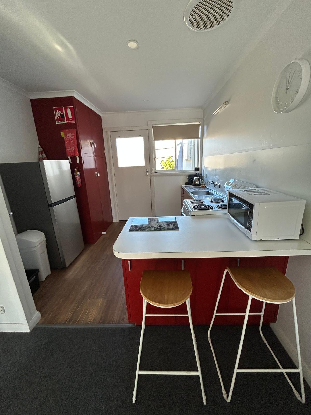 Fully equipped kitchen with breakfast bar in Apartment One