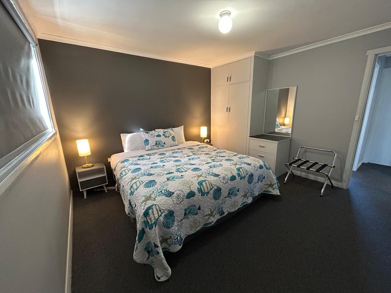 Main bedroom with double bed in Apartment Three
