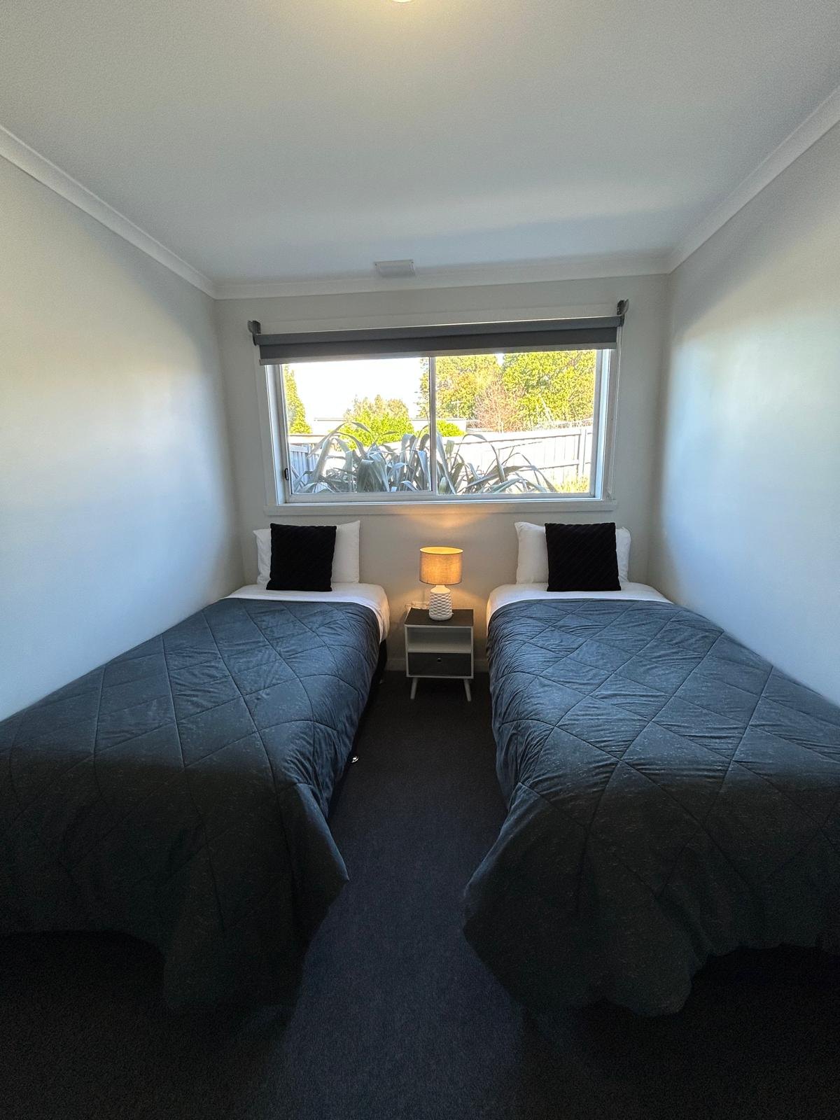 Second bedroom with twin single beds in Apartment Three