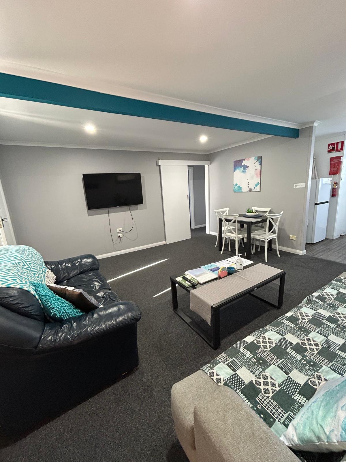 Lounge seating with flat-screen TV in Apartment Two