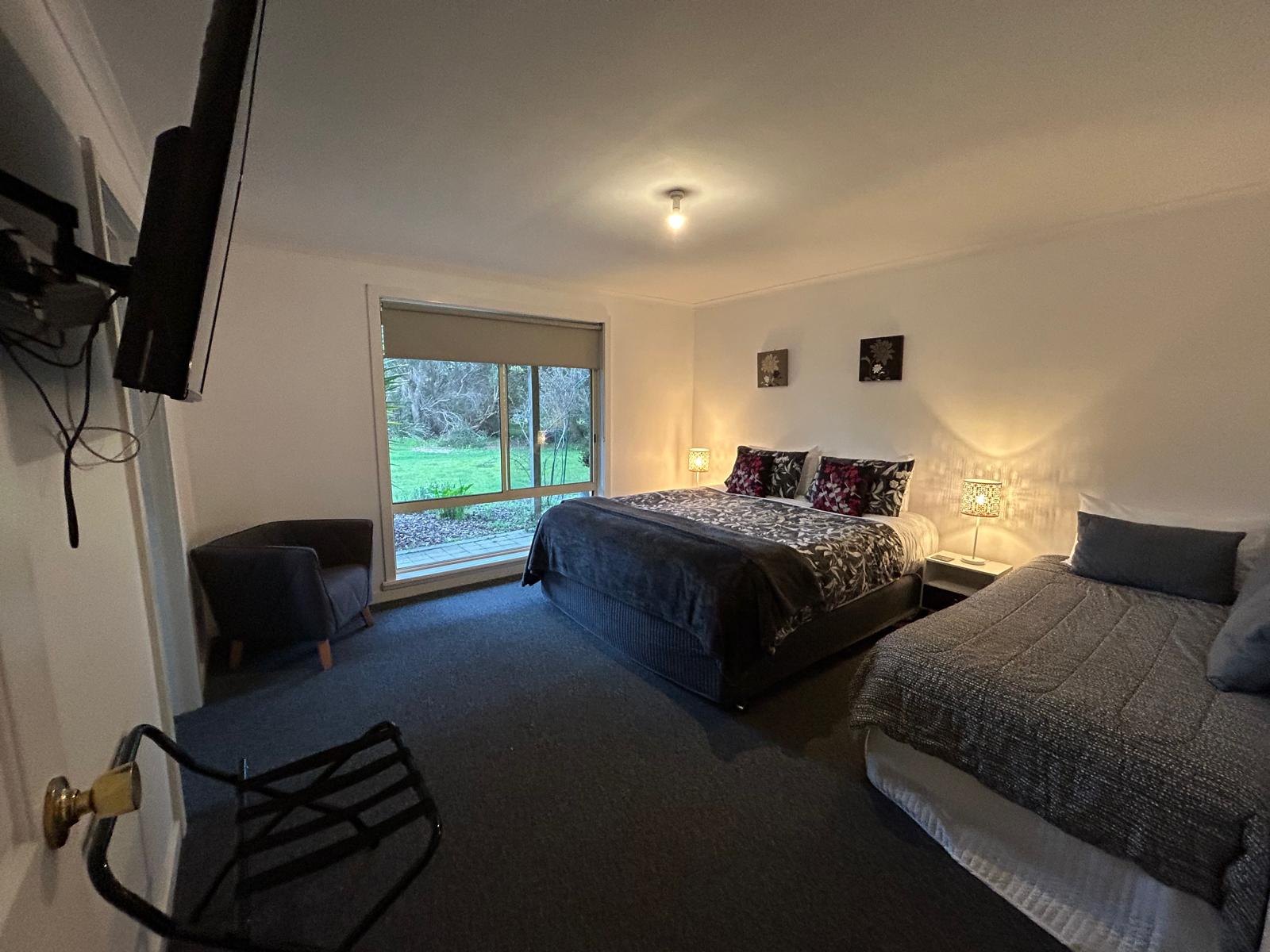 Main bedroom with large double bed and teal bedspread