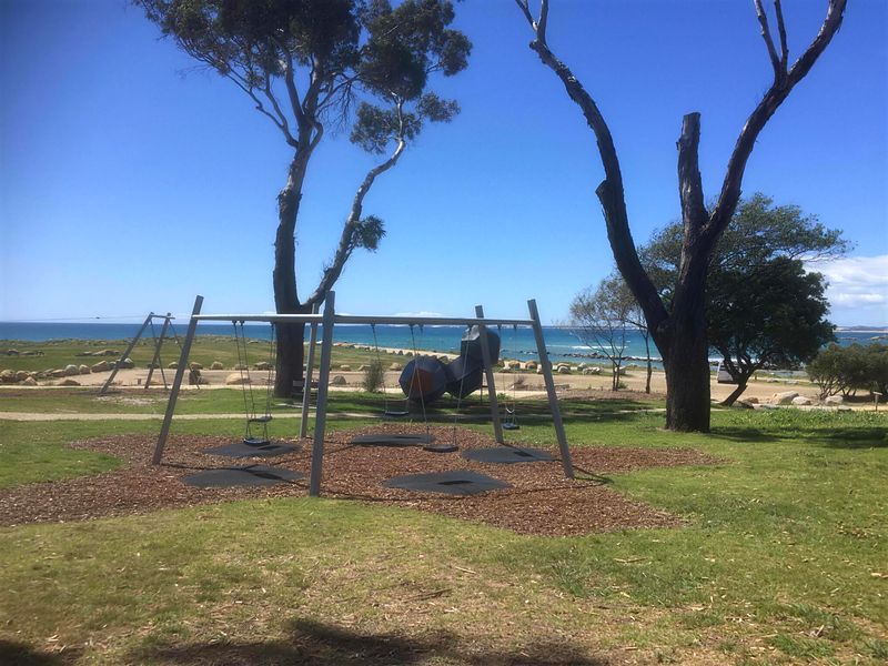 Swings at the foreshore playground with sea views