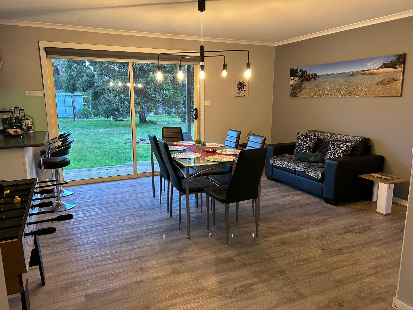 Dining area with the games table and glass doors out to the lawn
